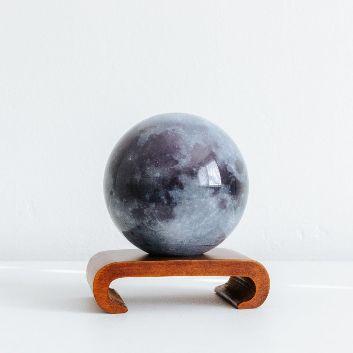 MOVA Moon globe on curved wooden stand, stylish astronomy-themed home decor and unique space gift