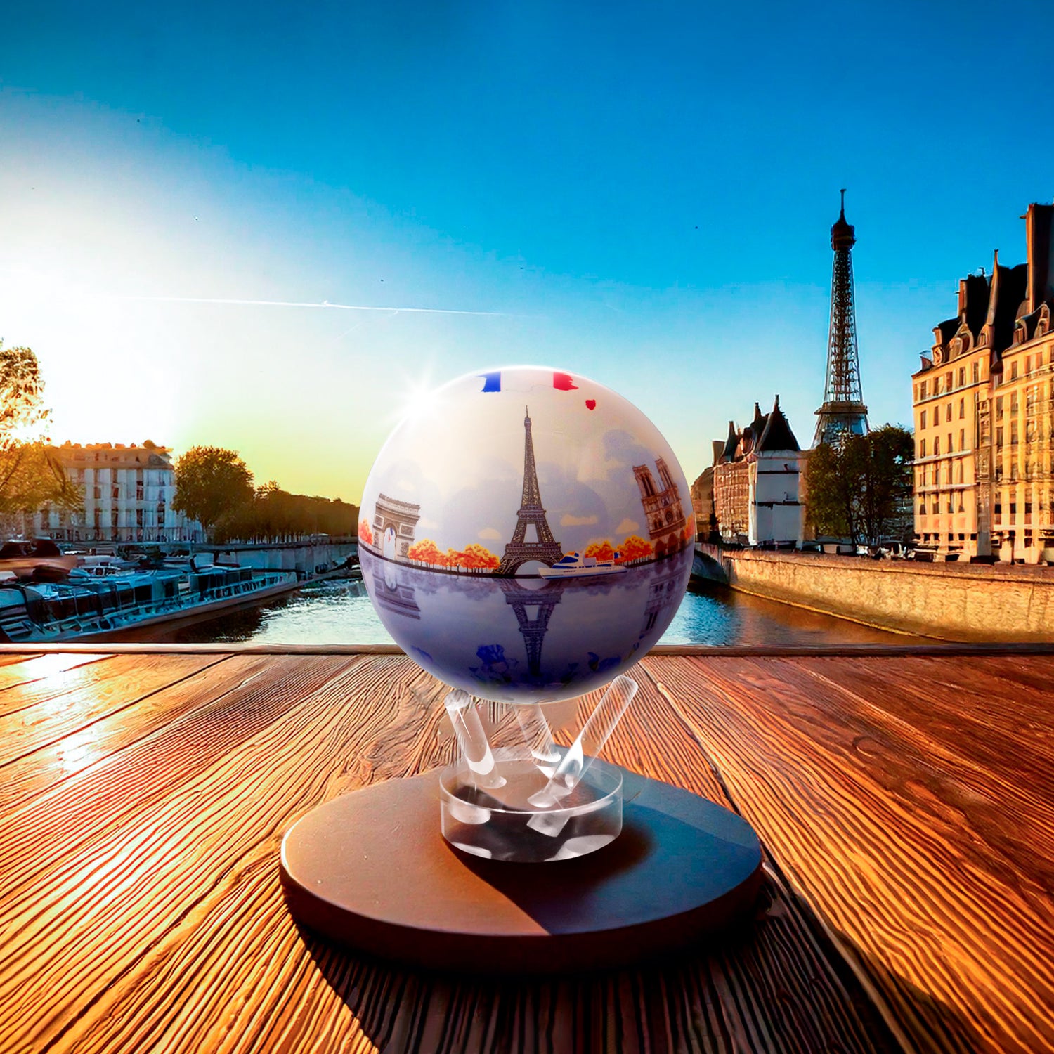 CITY SERIES PARIS GLOBE MOVA displayed outdoors with Eiffel Tower at sunset and Seine reflections.