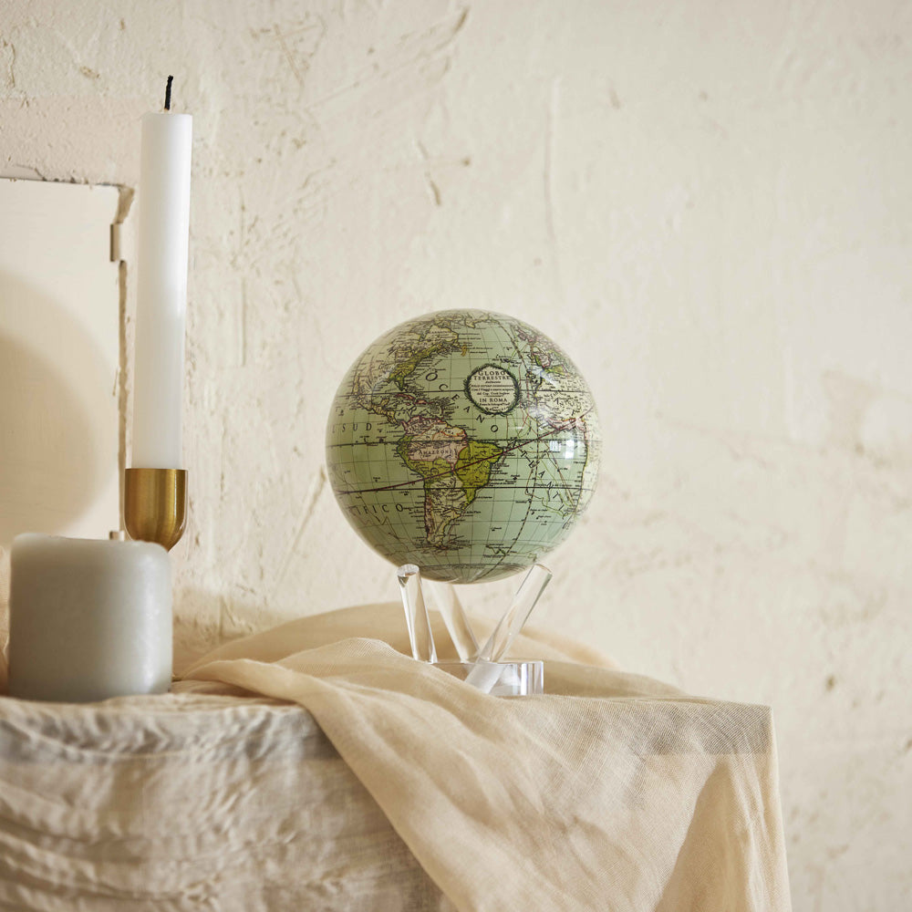 Antique Cassini Green MOVA Globe styled in a serene bedroom