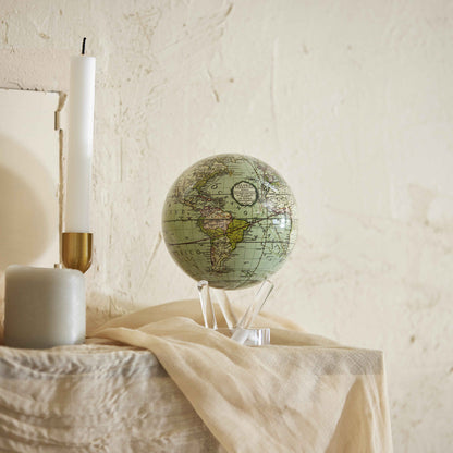 Antique Cassini Green MOVA Globe styled in a serene bedroom