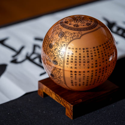 HEART SUTRA GOLD GLOBE on wood base, luxury rotating collectible combining Buddhist wisdom and modern design.