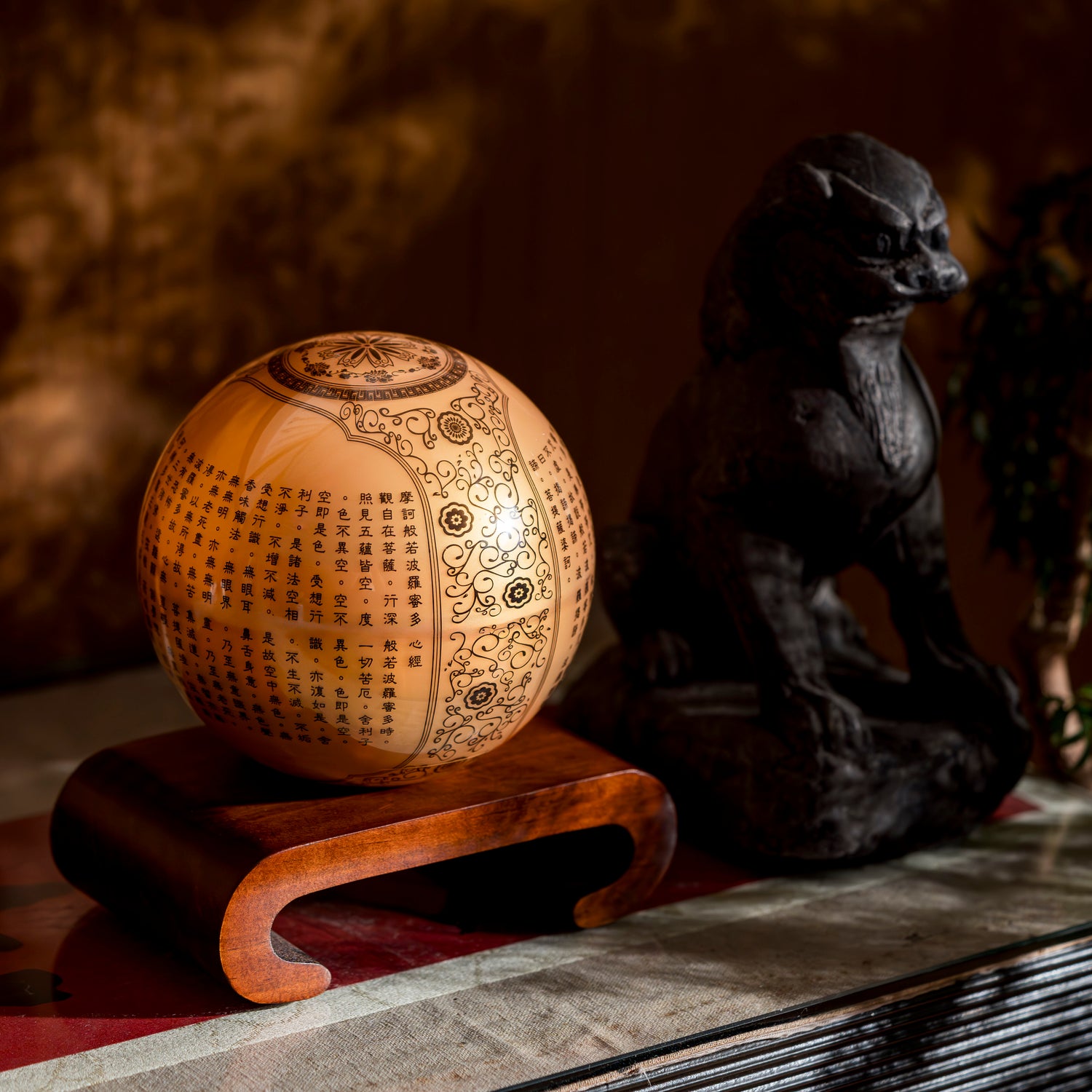 HEART SUTRA GOLD GLOBE on curved wood stand, elegant feng shui inspired décor with rotating Buddhist scripture sphere.