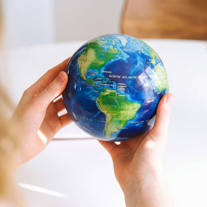 Earth Turquoise Gem MOVA Globe held in hand