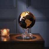 MOVA Globe displayed on a dark wood side table