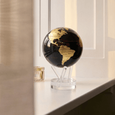 MOVA Globe displayed by a window in a modern interior
