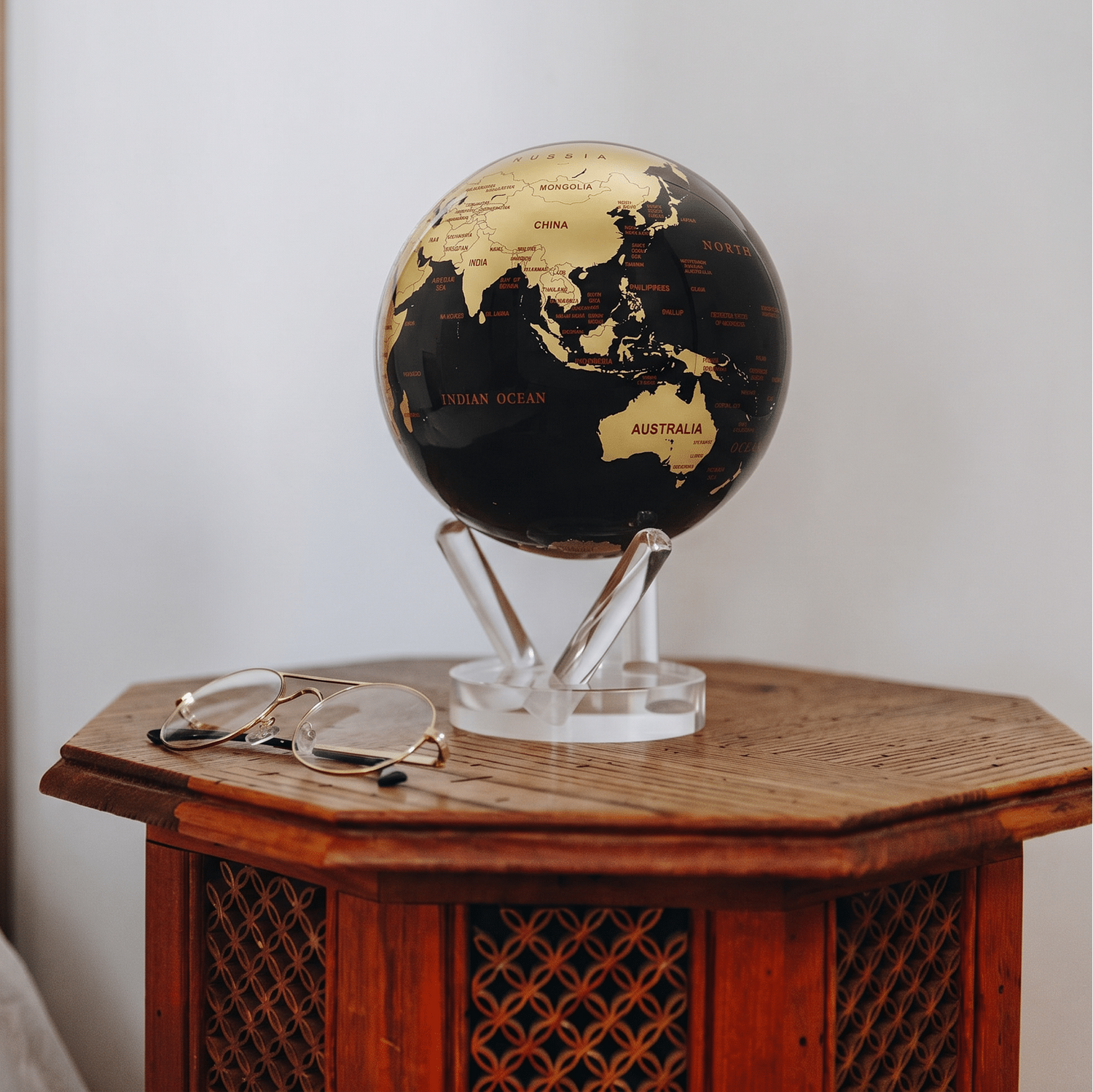 Decorative MOVA Globe on a vintage wood side table