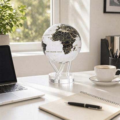 MOVA Globe on a bright workspace desk with laptop and notebook