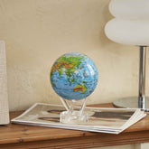 Ocean Blue Relief Map MOVA Globe styled on a wooden side table