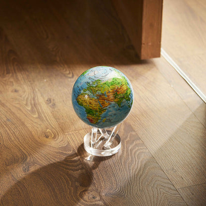 MOVA Globe illuminated by sunlight on a warm wood floor