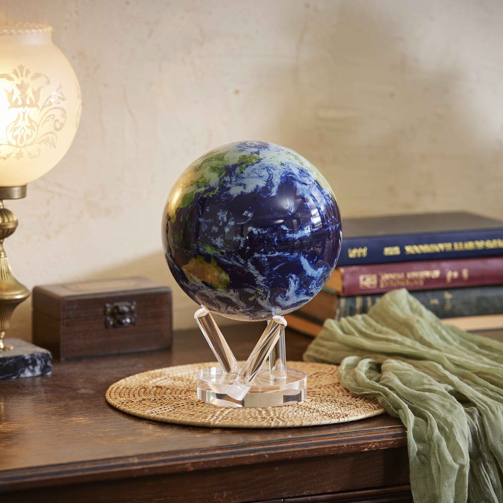 Satellite view MOVA Globe styled with books on a wooden table