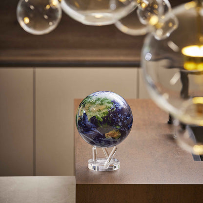 Earth MOVA Globe displayed in a modern interior with glass decor